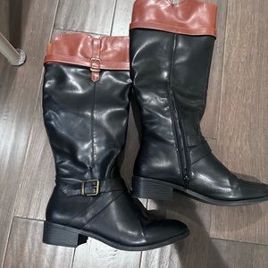Tan and black riding boots